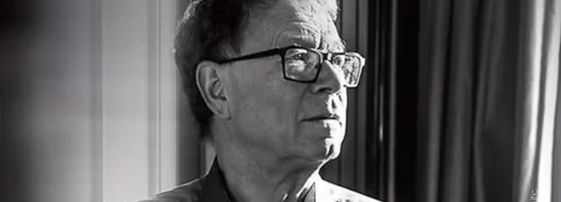 Zwart-witportret van Manu Keirse, gefotografeerd bij een raam.